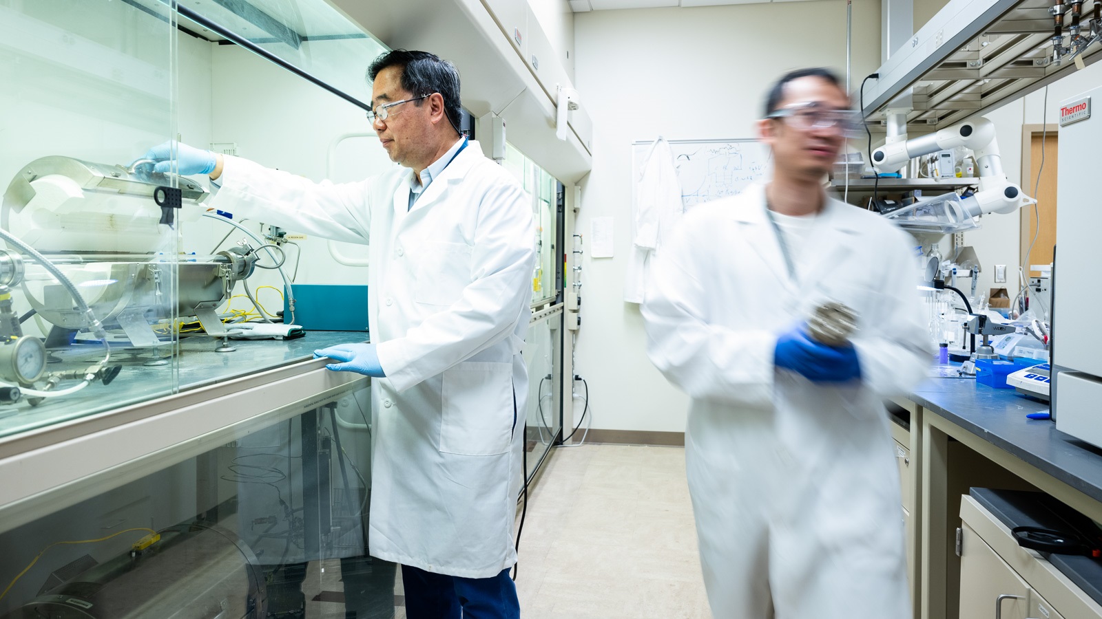 Chemist Di-Jia Liu working in the catalyst lab with postdoc Chenzhao Li.