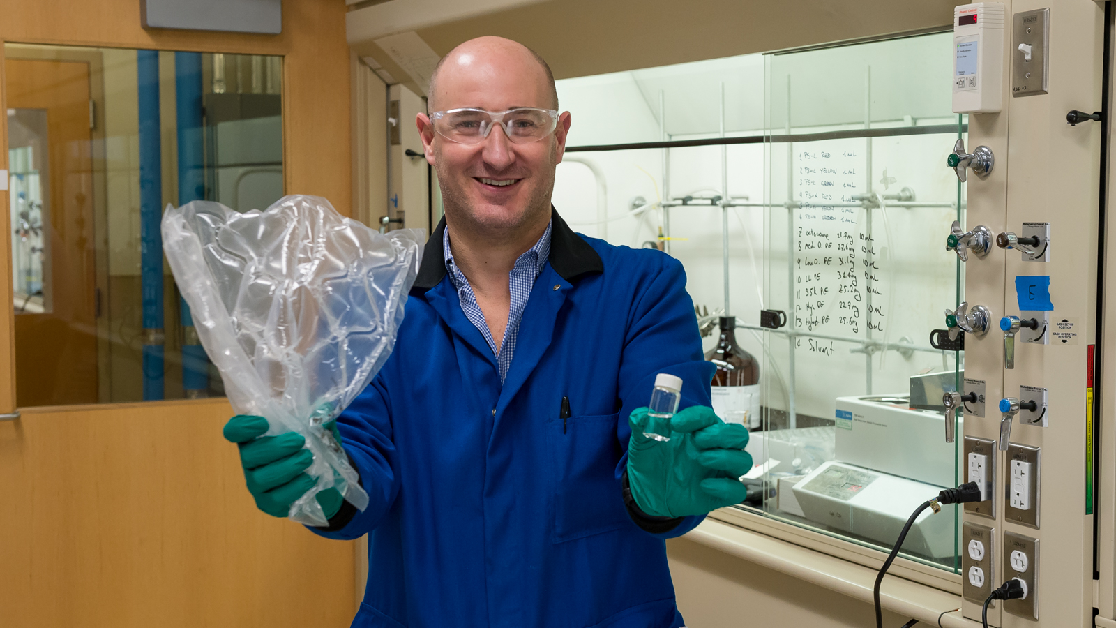 Max Delferro holding high-quality liquid product (left hand) obtained from treatment of plastic bag with new catalytic process. (Image by Mark Lopez / Argonne National Laboratory.)