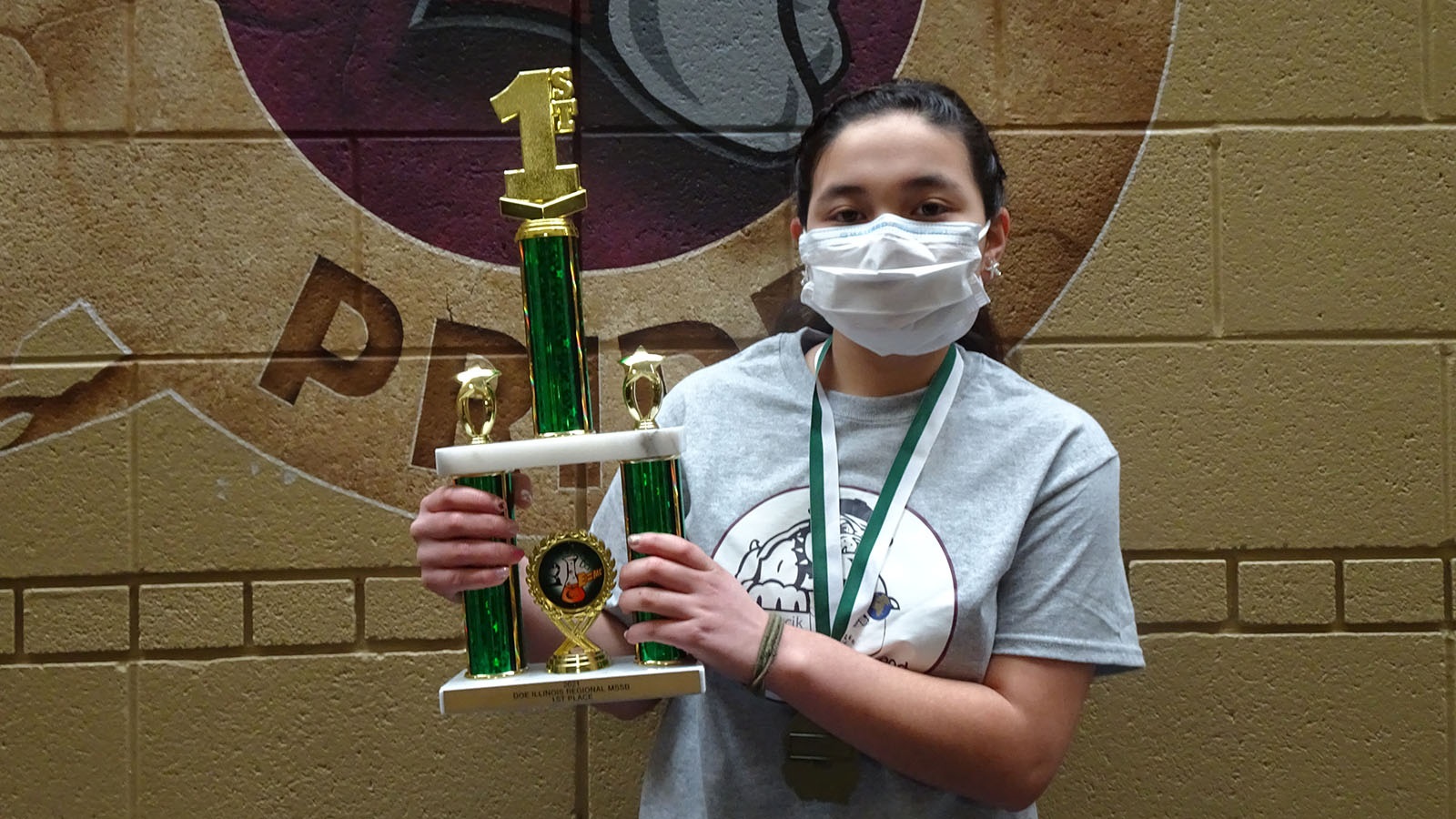 A student from Bednarcik Junior High School proudly displays her team’s first-place trophy from the 2021 Illinois Middle School Regional Science Bowl. (Image by Bednarcik Junior High School.)