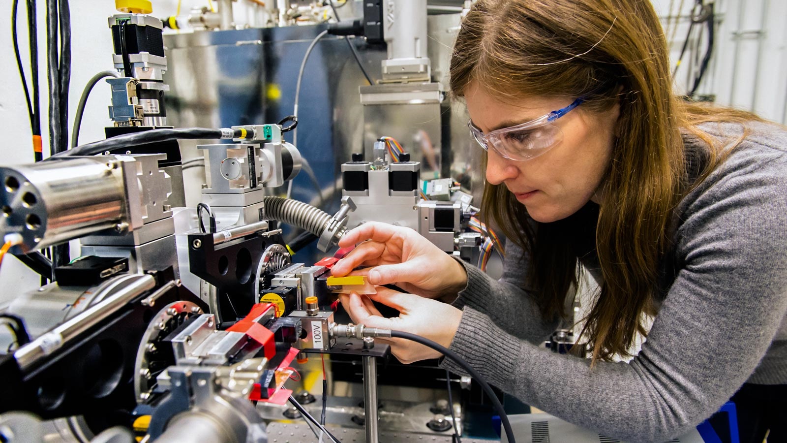 Physicist aligns a high-resolution monochromator. aligns a high-resolution monochromator 