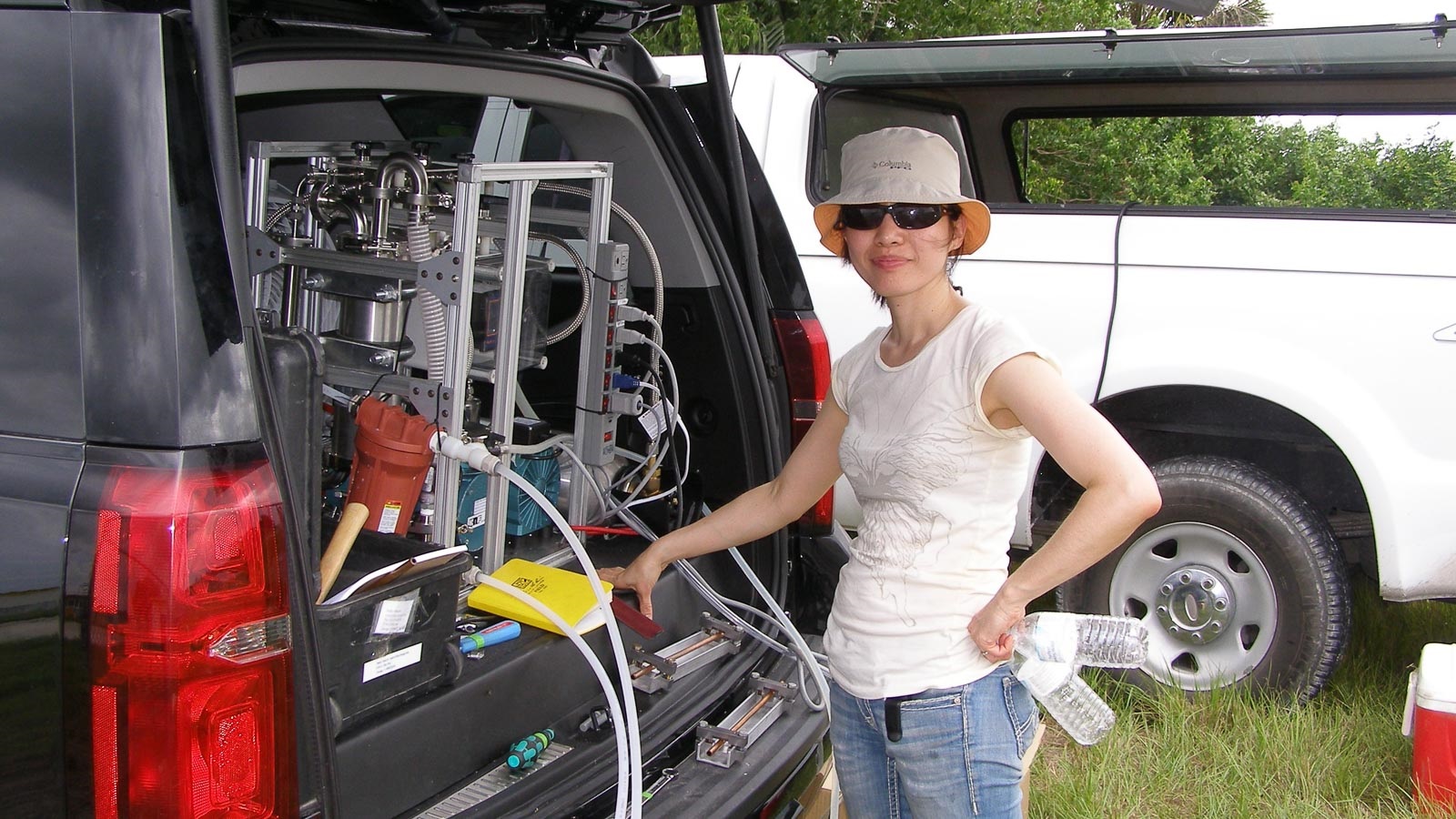 Scientist standing at back of van with equipment. (Image by Argonne National Laboratory.)
