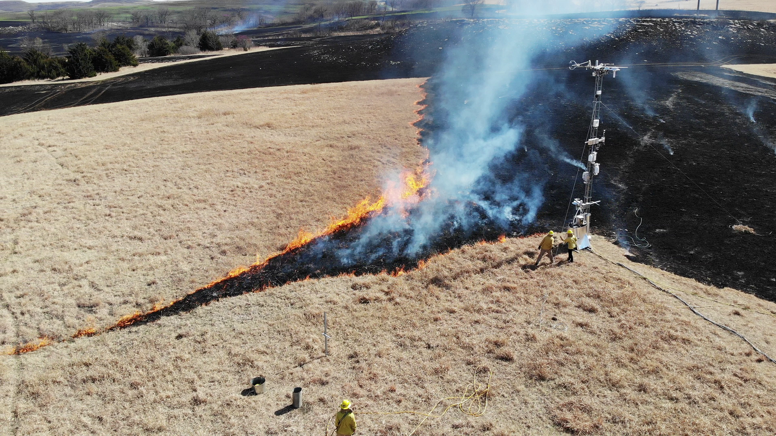 Yellow-jacketed figures putting out a fire. (Image by Rajesh Sankaran/Argonne National Laboratory.)