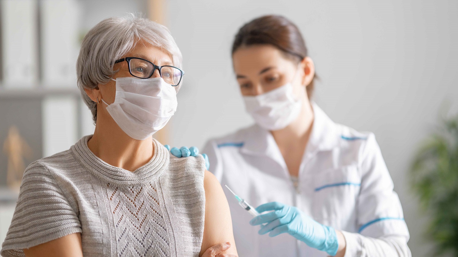 nurse vaccinating a patient