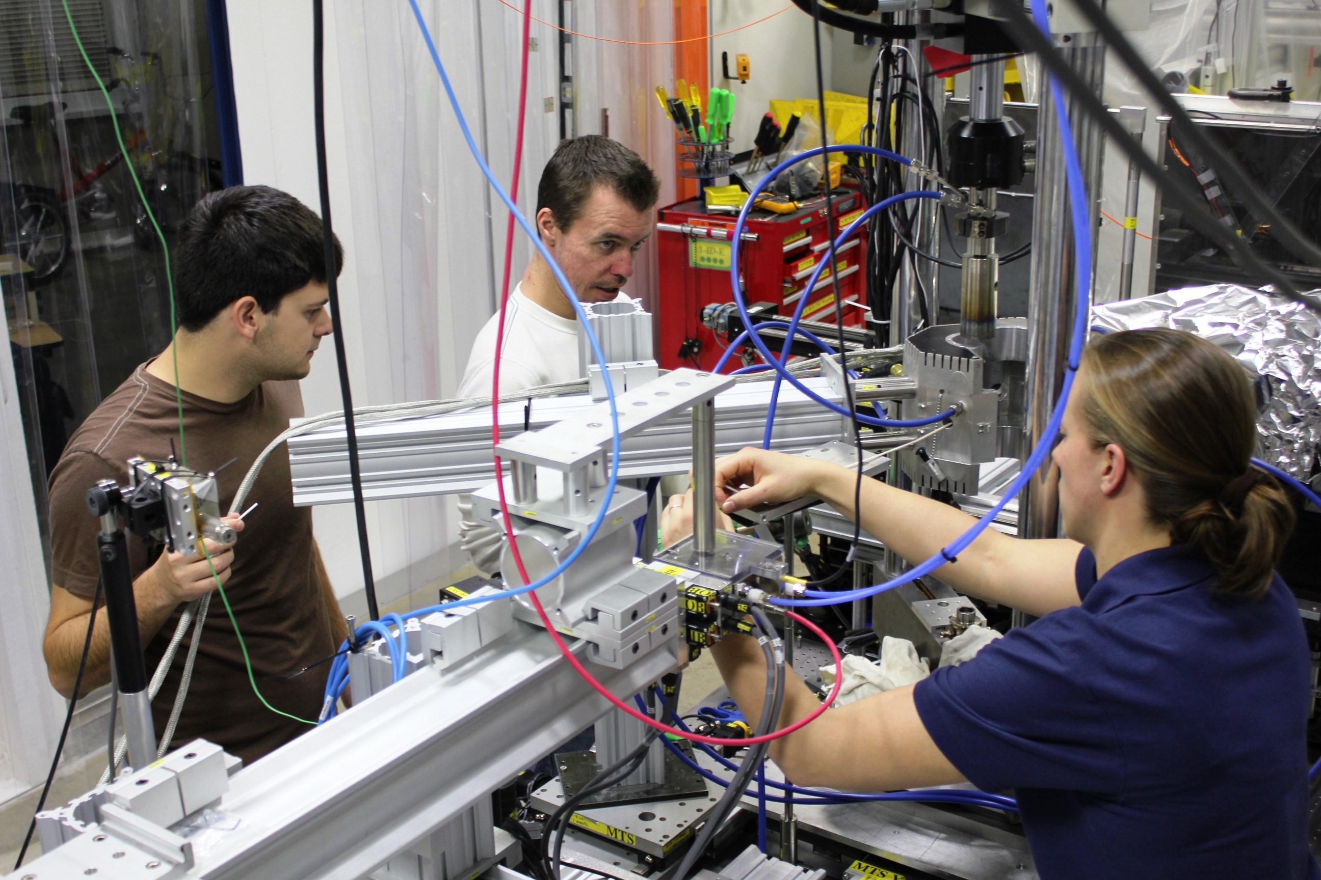 (From left) University of Central Florida Ph.D. students Albert Manero and Kevin Knipe work with Janine Wischek, head of the Mechanical Testing of Materials Group from the German Aerospace Center, to integrate the unique experimental X-ray setup at the Advanced Photon Source at Argonne National Lab.