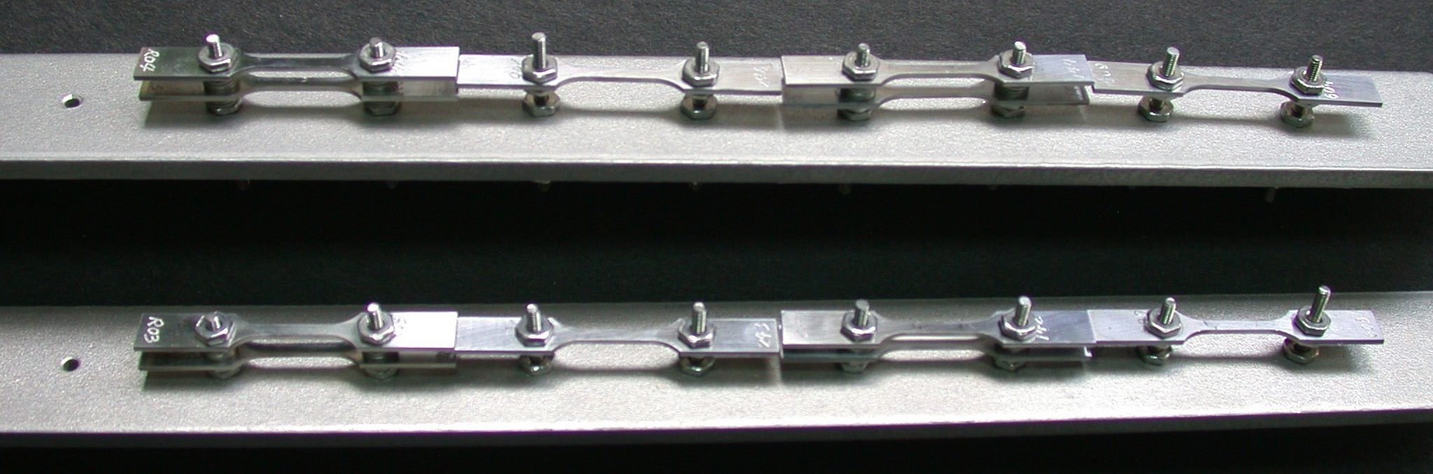 Flat tensile samples mounted on sample holders ready for sodium-exposure experiment