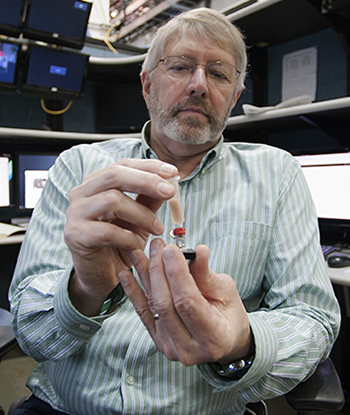 Prof. Stuart Stock (Northwestern University) displays the shark spine sample prior to imaging studies using high-brightness X-rays at the X-ray Science Division beamline 2-BM research station at the Advanced Photon Source. (Image by Argonne National Laboratory.)