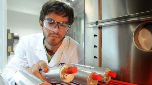 Panagiotis Prezas examines a battery cell in Argonne's Electrochemical Analysis and Diagnostics Lab