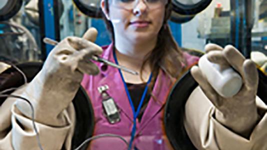 Frances Dozier conducts research on recycling used nuclear fuel in a glovebox at Argonne National Laboratory.
