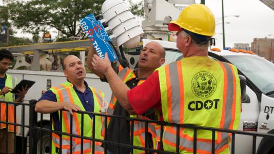 Chicago Department of Transportation workers install the first public Array of Things node at the intersection of Damen and Archer Avenues in Chicago.