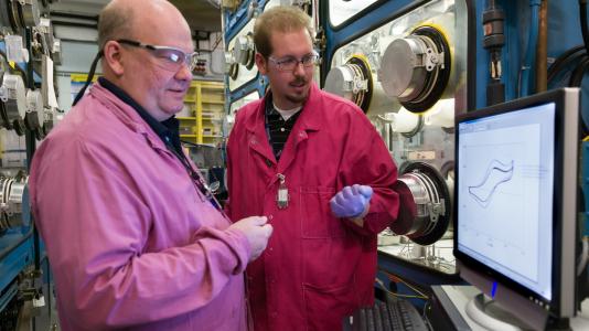 Argonne researchers Jim Willit (left) and Nick Smith review data from in-situ process monitoring for pyrochemical systems.