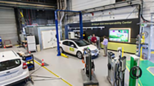 Engineers Jason Harper (left) and Daniel Dobrzynski at work in Argonne’s Electric Vehicle Interoperability Center, which seeks to create worldwide standards for electric car plugs and charging stations.