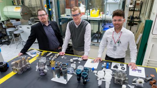 For the first time, Argonne scientists have printed 3D parts that pave the way to recycling up to 97 percent of the waste produced by nuclear reactors. From left to right: Peter Kozak, Andrew Breshears, M Alex Brown, co-authors of a recent Scientific Reports article detailing their breakthrough. (Image by Argonne National Laboratory.)
