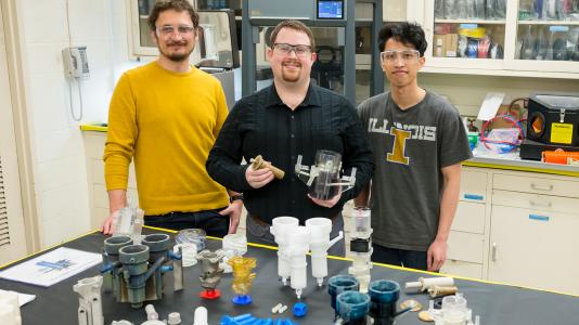 The laboratory’s new 3D printing methods makes make its recycling method – pioneered in 2015 by Mo-99 program manager Peter Tkac (left) and others – faster, more reliable, and more cost effective. Also shown: Peter Kozak (center) and Brian Saboriendo. Not shown: Alex Brown. (Image by Argonne National Laboratory.)