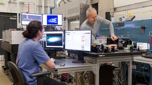 Joseph Libera and Anthony Stark prepare for in-situ Raman spectroscopy. (Image by Argonne National Laboratory.)