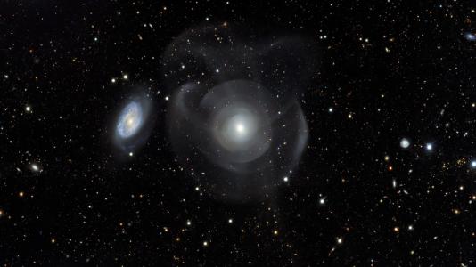 1.	Shown here is the elliptical galaxy NGC 474 with star shells. Elliptical galaxies are characterized by their relatively smooth appearance as compared with spiral galaxies. (Image by the Dark Energy Survey team.)