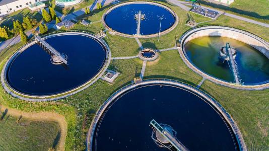This is an aerial view of a modern industrial sewage treatment plant. Water quality directly contributes to the global health, and wastewater-based epidemiology could help monitor community-level infection of diseases, such as COVID-19. (Image by Daniel Jedzura/Shutterstock.)