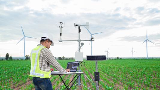 scientist in field with equipment