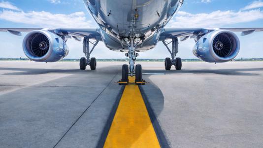 Underside of airplane on runway. Image by Shutterstock/frank_peters.)