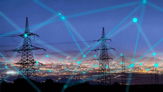 Electricity flashes between poles against night sky. (Image by Shutterstock/urbans.)