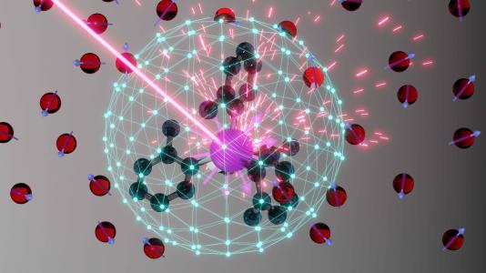 Clear prismed spherical shape with red circles, beam centering on pink spikey object amidst green circular connectors. (Image by MIT/Dan Laorenza.)