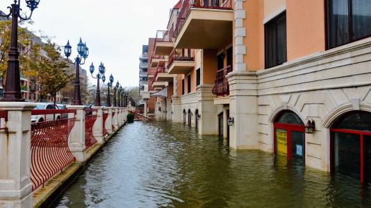 Flooding of lower street level buildings adjacent to bridge. (Image by Shutterstock/FashionStock.com.)