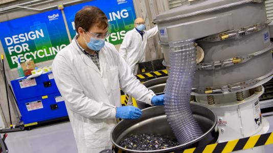 Two researchers separating materials in the lab.