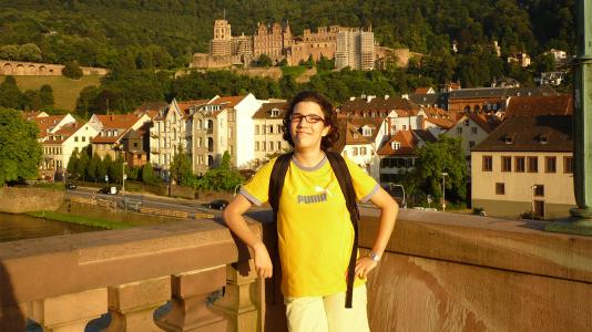 Afroditi Papdopoulou standing with a European town in the background.