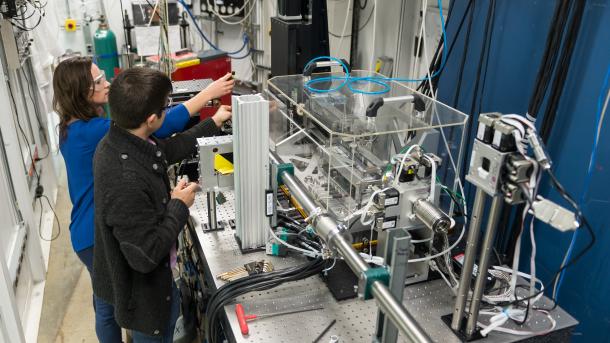 Brandon Sforzo and a former colleague prepare an experiment to investigate fuel injector design at the Advanced Photon Source.