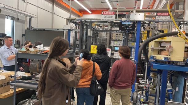 Undergraduate students are guided by a physicist through the Argonne Tandem Linac Accelerator System.